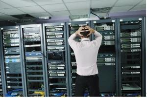 man stressed in front of server